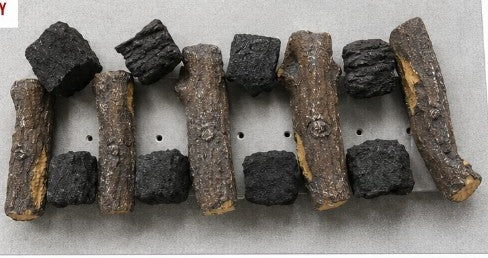 Base layer on a rectangular burner: smaller ceramic logs with coals in the gaps, leaving gas ports clear